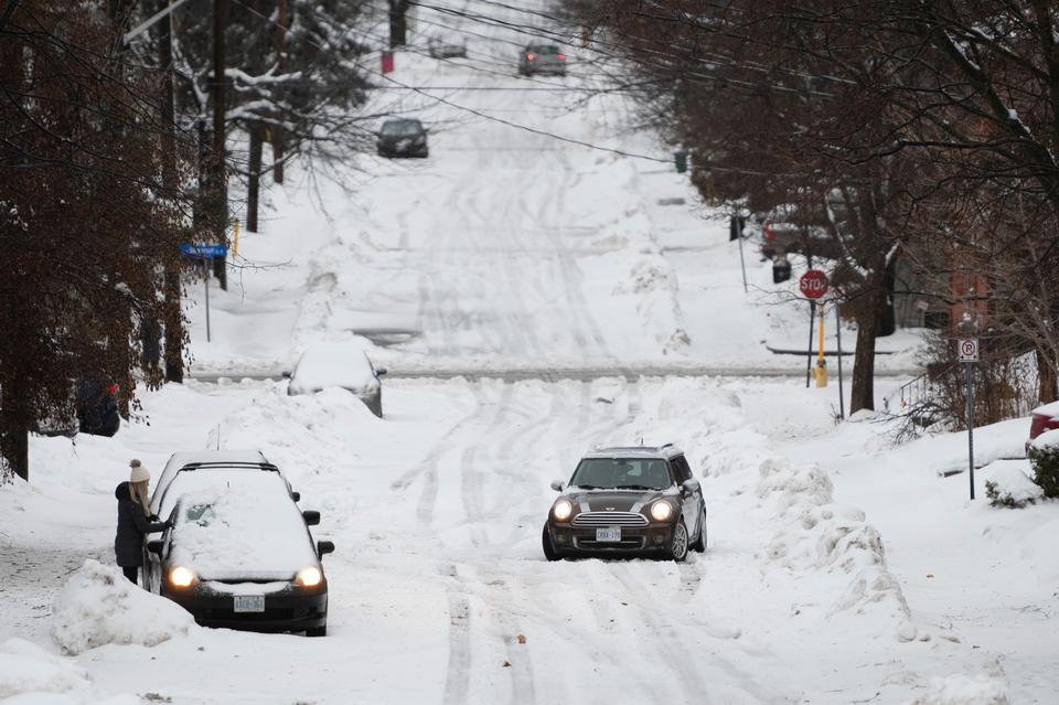 A car sits stuck on a road in the Sandy Hill neighborhood of Ottawa.