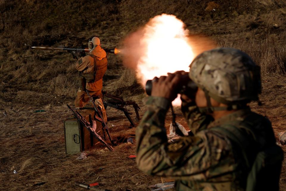 A soldier from Carpathian Sich international battalion fires an RPG while conducting manoeuvres near the front line, as Russia's attack on Ukraine continues, in Kreminna, Ukraine, January 3, 2023.