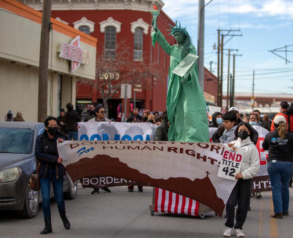 Several hundred march through the streets of El Paso a day before President Joe Biden's first, politically-thorny visit to the southern border.