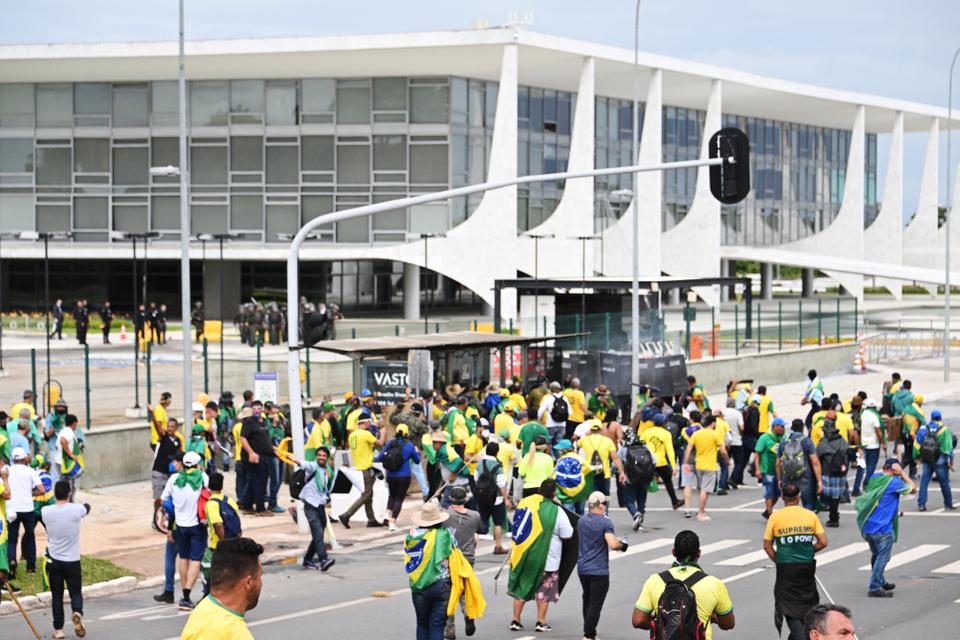 In startling images uploaded to social media, a tide of people stormed the national Congress, many waving Brazilian flags.