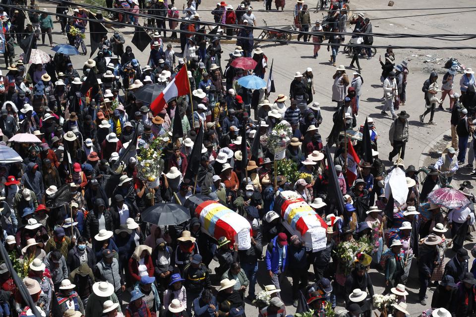 Relatives and friends of the victims of clashes with the Peruvian police carry their coffins in the Andean city of Juliaca, southern Peru.