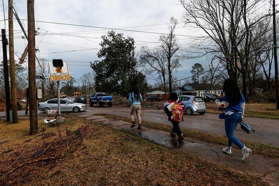 Kids walk home from school after a tornado hit near Meadowview elementary school in Selma, Alabama.