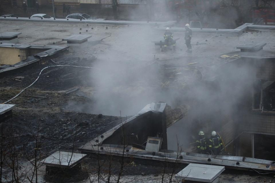 Emergency personnel work at the site of a helicopter crash
