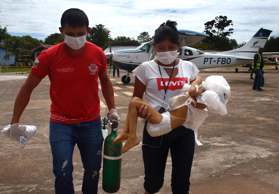 A health worker carries a Yanomami toddler, who was transported via an aeroplane for medical treatment at the Santo Antonio Children's Hospital, in Boa Vista, Roraima state, Brazil, Jan 29, 2023. Brazil's government declared a public health emergency for the Yanomami people in the Amazon, who are suffering from malnutrition and diseases such as malaria.