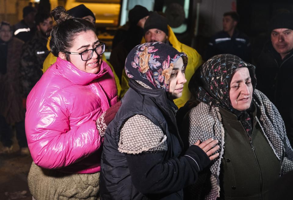 Relatives of earthquake victims in the Turkish province of Kahramanmaras wait as personnel conduct search and rescue operations early on Wednesday two days after 7.7 and 7.6 magnitude earthquakes hit the southern region of Turkiye and neighbouring Syria.