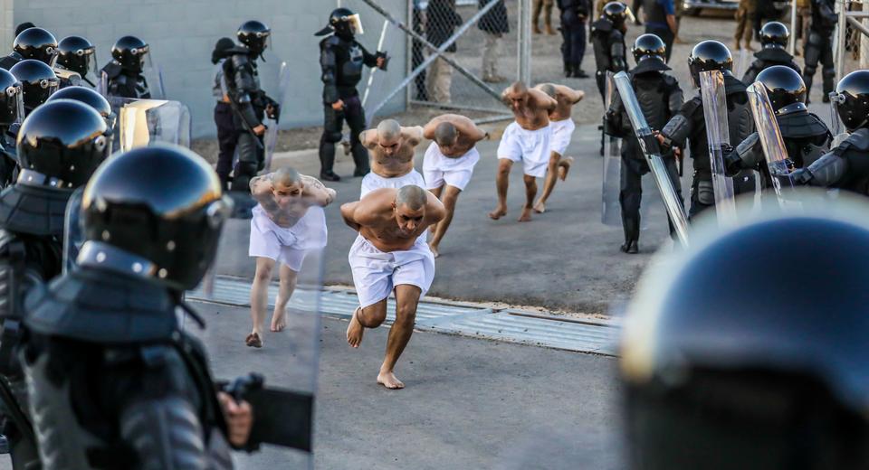 Prison agents observe imates as they are processed at their arrival after 2000 suspected gang members were transferred to Terrorism Confinement Center.