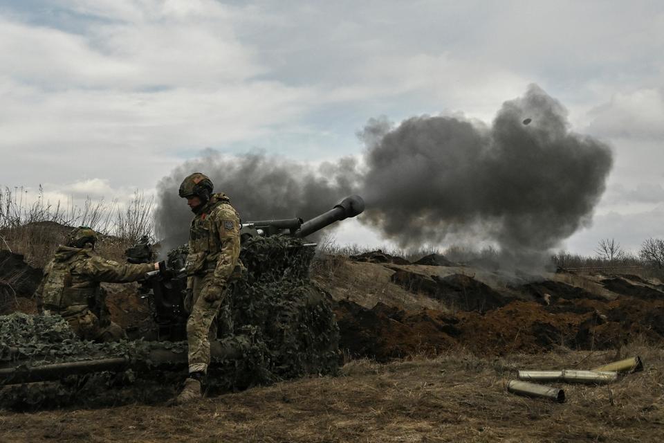 Ukrainian servicemen fire with a 105mm howitzer towards Russian positions near the city of Bakhmut.