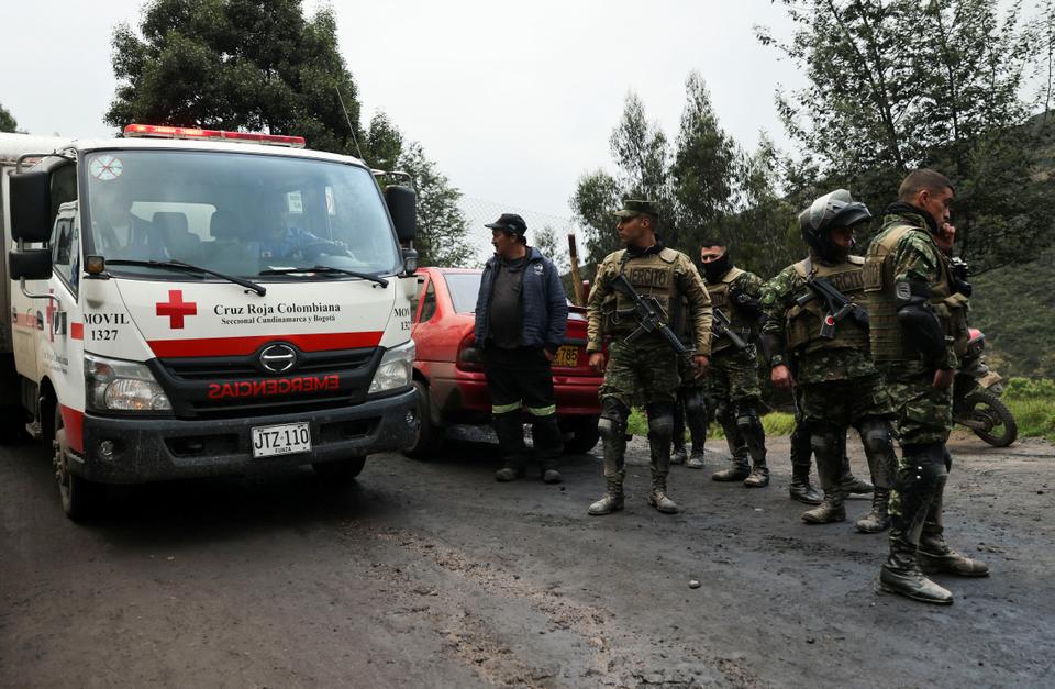 An ambulance arrives as rescue personnel continue the search for miners trapped following an explosion in a coal mine.