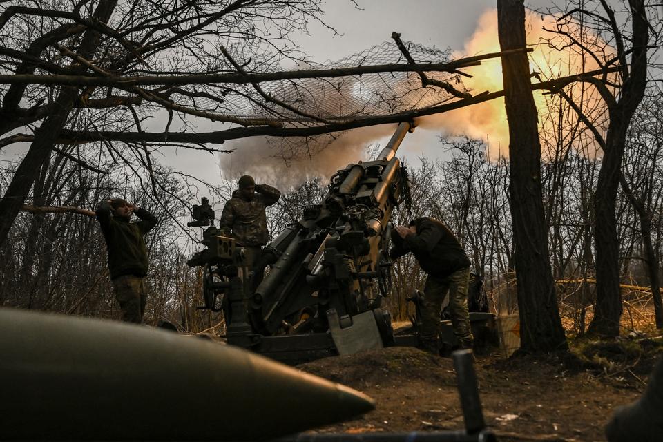 Ukrainian servicemen fire a M777 howitzer at Russian positions near Bakhmut, eastern Ukraine.