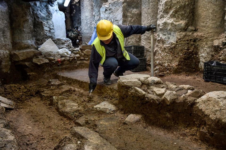 A man works on the excavation of an ancient site under the city centre of modern Thessaloniki, on April 25, 2018.