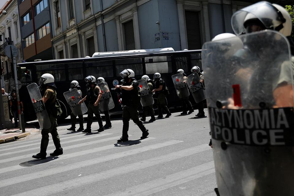 Riot police guard the Hellenic Business Federation offices during the demonstration marking a 24-hour general strike against planned austerity measures in Athens.
