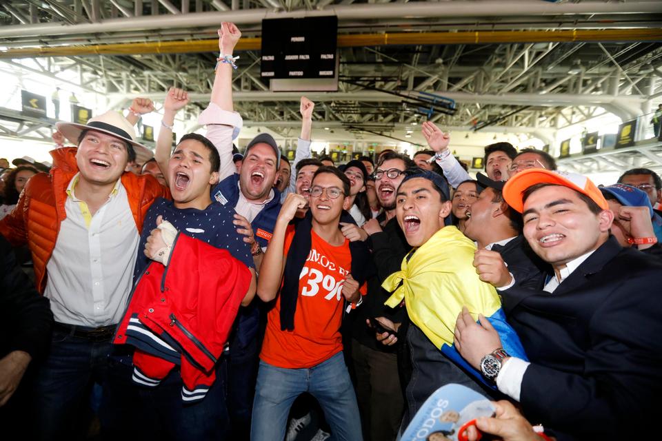 Supporters of presidential candidate Ivan Duque celebrate as voting tables are closed and ballot counting begins during the second round of the presidential election in Bogota, Colombia, June 17, 2018.
