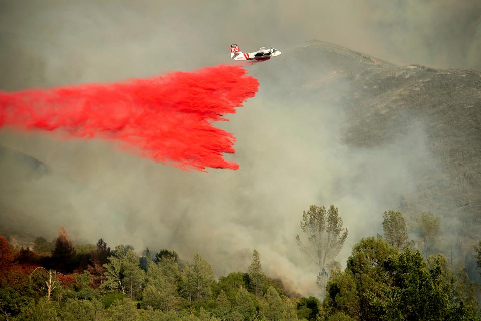 An air tanker drops retardant on a wildfire burning above the Spring Lakes community, June 24, 2018