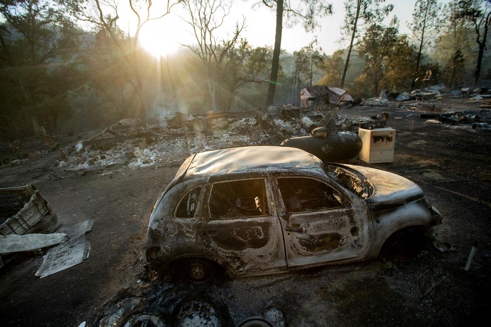 A vehicle scorched by a wildfire rests in a clearing on Wolf Creek Road near Clearlake Oaks, California, June 24, 2018.