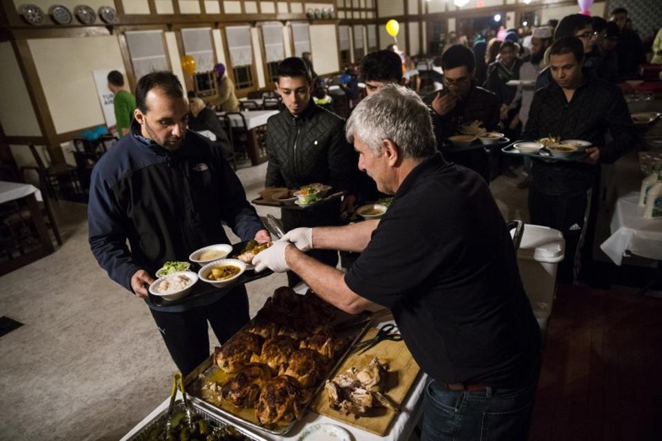 People are served dinner after the celebrations at the Diyanet Center of America near Washington DC. 