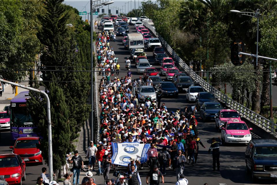 A group of Central American migrants, representing the thousands participating in a caravan trying to reach the U.S. border, undertake an hours-long march to the office of the United Nations' humans rights body in Mexico City, Thursday, November 8, 2018.