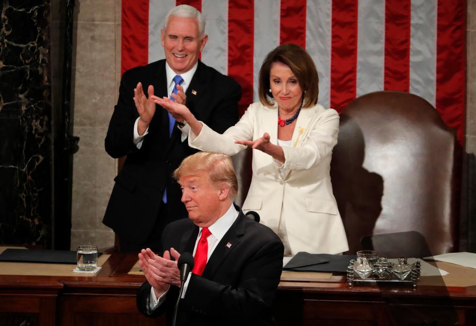 Speaker of the House Nancy Pelosi (D-CA) and Vice President Mike Pence react as female Democrat members of the House of Representatives applaud President Donald Trump after he said that there are now more women in Congress than ever during his second State of the Union address to a joint session of the US Congress in the House Chamber of the U.S. Capitol on Capitol Hill in Washington, US February 5, 2019.