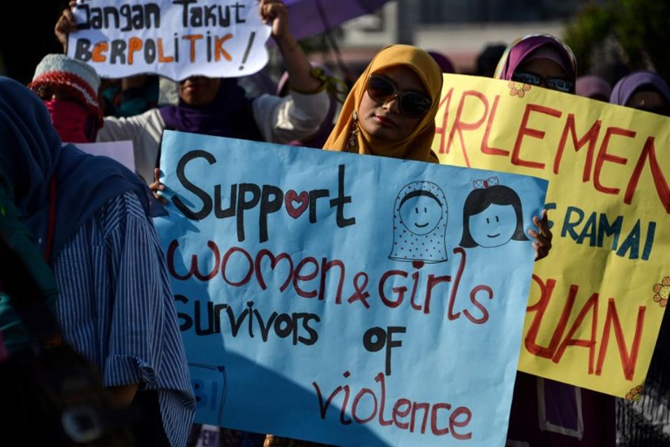 Activists takes part in an event to mark International Women's Day in Banda Aceh, Aceh province on March 8, 2019.