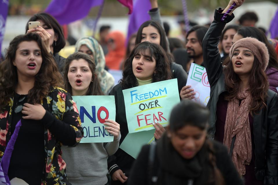 Pakistani civil society activists carry placard and shout slogans during a rally for women rights on International Women's Day in Islamabad on March 8, 2019.