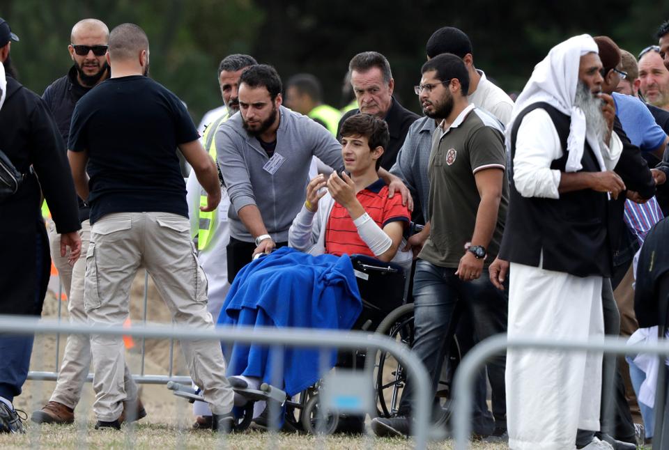 Zaid Mustafa sits in his wheelchair and prays for his brother Hamza and father Khalid at their funeral at the Memorial Park Cemetery in Christchurch, New Zealand, on March 20, 2019. Zaid was injured during the shooting.