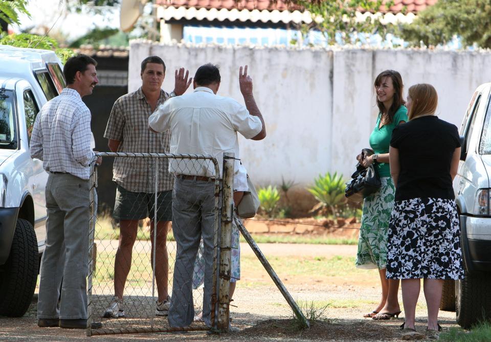 Some of the 11 Zimbabwean white farmers are seen after their court hearing in Chegutu, Zimbabwe Wednesday, Oct. 31, 2007. The farmers were brought to court to answer charges of breaching land laws by defying a government eviction order. The trial date was postponed to a later date.
