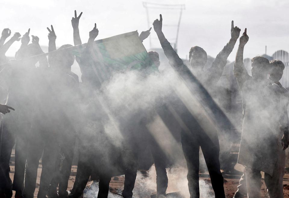 Kashmiri men shout slogans during clashes with Indian security forces, after scrapping of the special constitutional status for Kashmir by the Indian government, in Srinagar, August 23, 2019.
