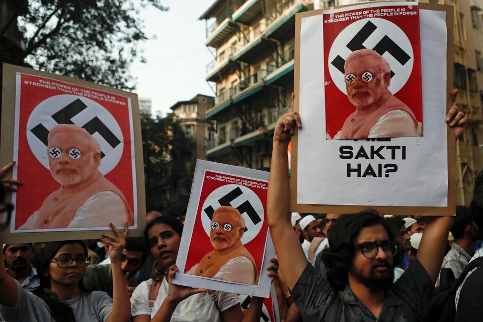 Demonstrators hold placards during a protest against a new citizenship law, in Mumbai, India, December 19, 2019.