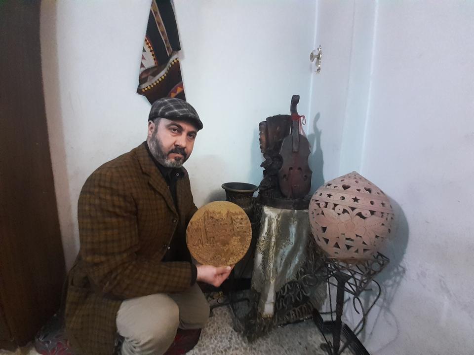 Mustafa Deeb shows his recent artwork he carved out of clay.