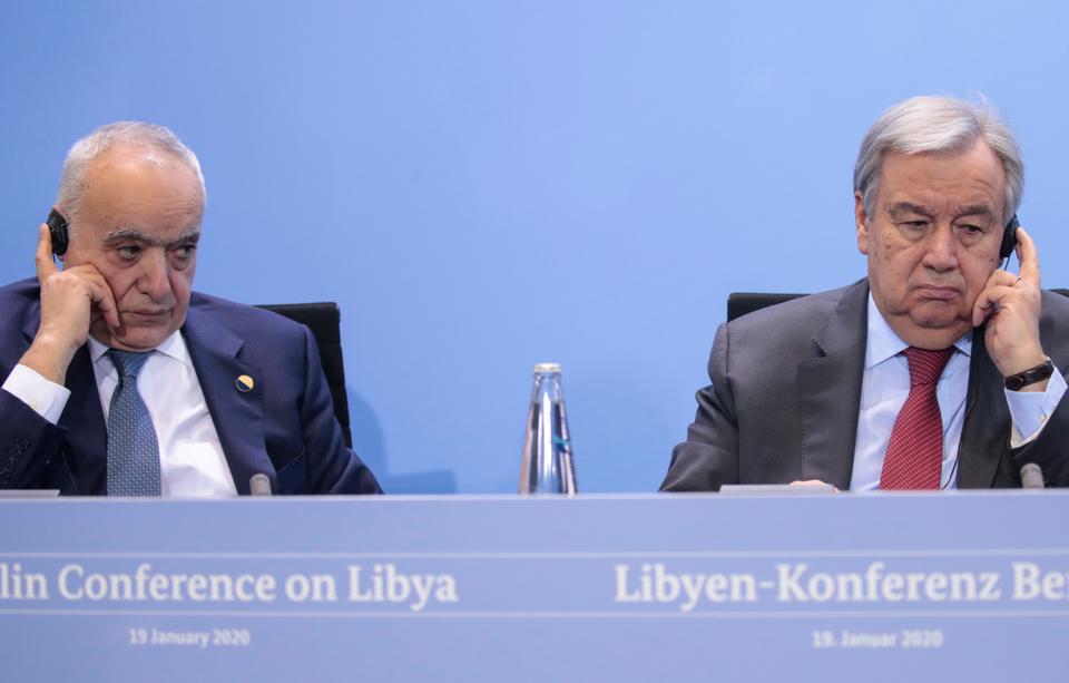 UN envoy for Libya Ghassan Salame and United Nations Secretary-General Antonio Guterres adjust their earphones as they attend a news conference after the Libya summit in Berlin, Germany, January 19, 2020.