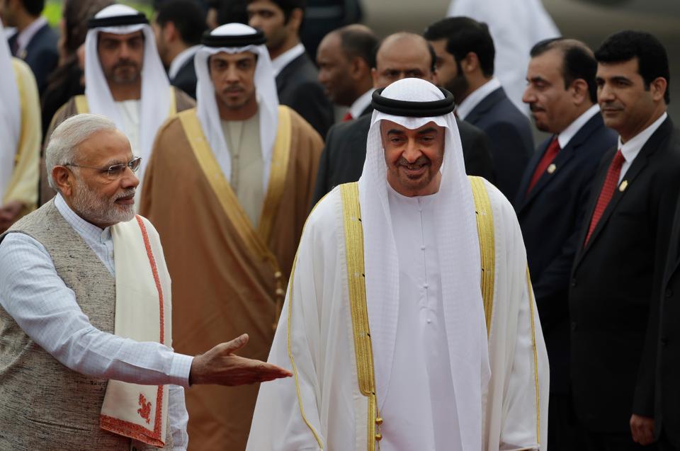 Indian Prime Minister Narendra Modi, left, gestures as he receives Abu Dhabi's crown prince, Sheikh Mohammed bin Zayed Al Nahyan at the airport in New Delhi, India, Jan. 24, 2017.