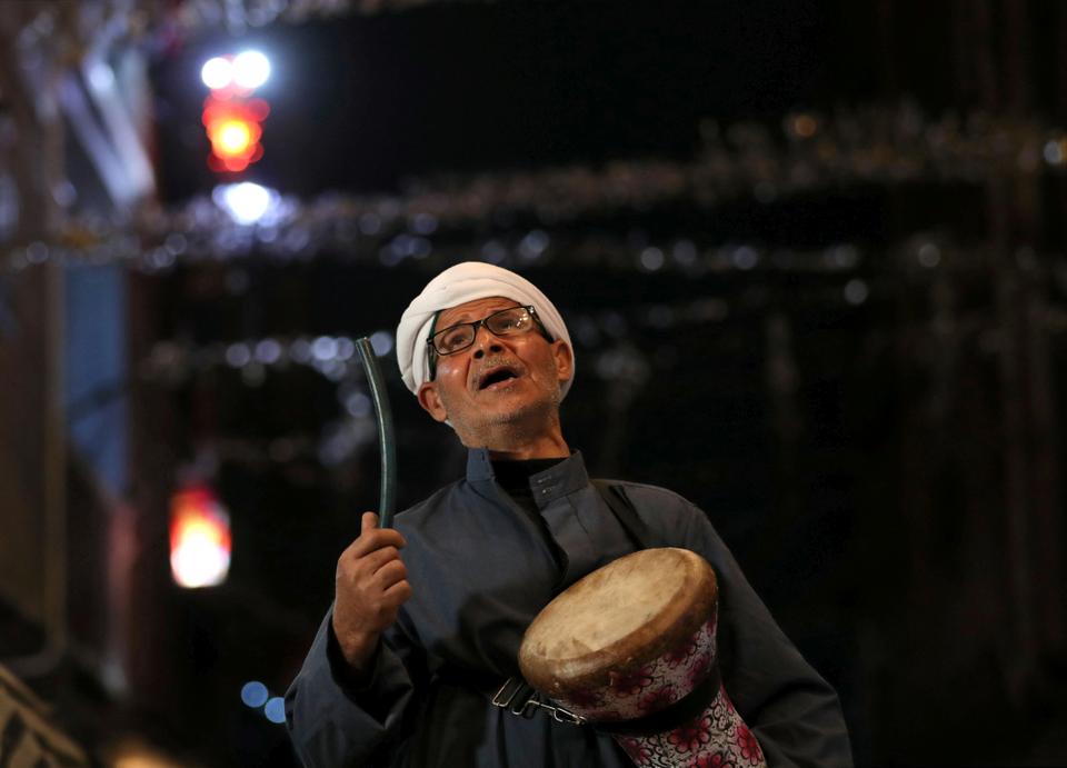 Al-Masharty Moustafa, 60, beats a drum as he wakes residents to eat their pre-dawn Sahur meals before beginning their fasting for the day during the Muslim Holy month of Ramadan, in Cairo, as Egypt ramps up efforts to slow the spread of the coronavirus disease (COVID-19), April 29, 2020.