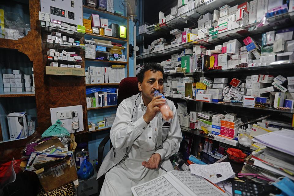 Manzoor Ahmad, a pharmacy owner breaking his fast at his shop. The hospitals with poor infrastructure in the region have been struggling to meet the health crisis caused by pandemic. There have been more than 1,000 positive coronavirus cases and 19 deaths. India-administered Kashmir continues under lockdown to combat the virus.