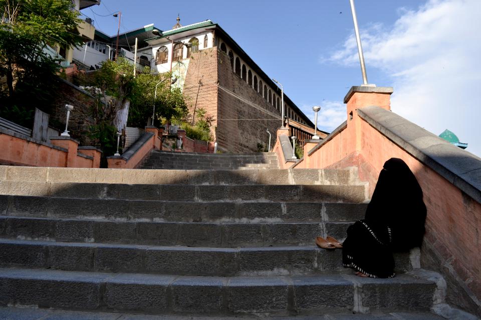 Khadija, a destitute woman sitting on the stairs of a mosque in Srinagar, India-administered Kashmir, as places of worship are under lockdown in the holy month of Ramadan.