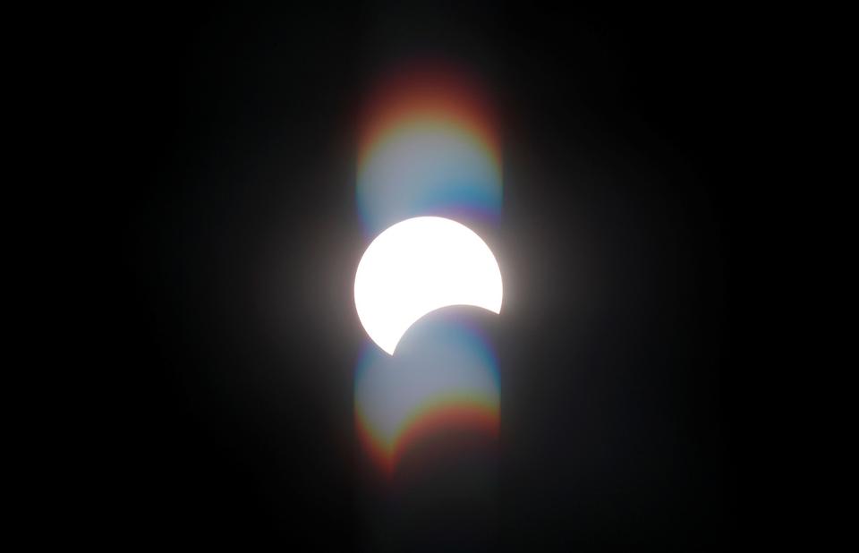 A partial solar eclipse is seen from the Cairo suburb of Maadi, Egypt.