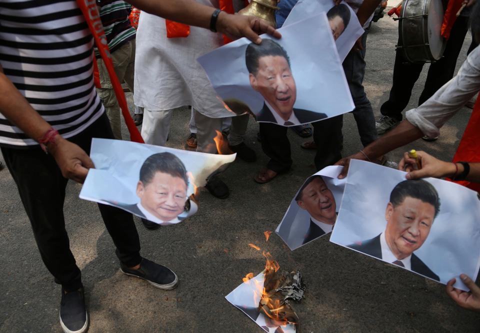 India far-right activists burn the photos of Chinese President Xi Jinping during a protest over the killing of 20 Indian soldiers by the Chinese army in the Ladakh territory of disputed Jammu and Kashmir.