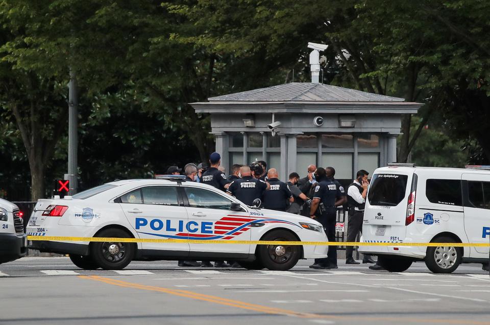 Police officers stand guard after a shooting incident outside of the White House, in Washington, US, August 10, 2020.