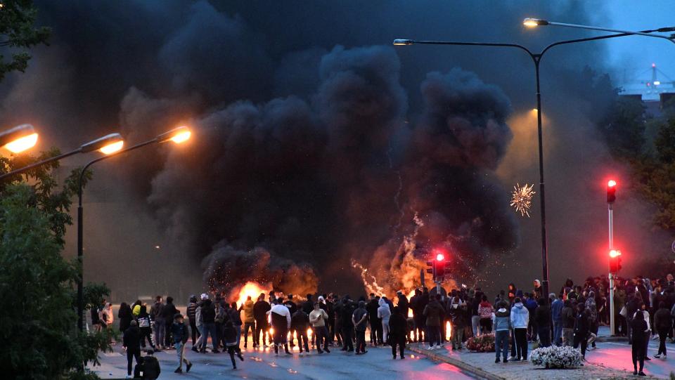 Smoke billows from the burning tyres, pallets and fireworks during a riot in Malmo, Sweden August 28, 2020.
