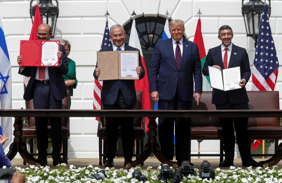 Bahrain’s Foreign Minister Abdullatif Al Zayani, Israel's Prime Minister Benjamin Netanyahu and UAE Foreign Minister Abdullah bin Zayed display their copies of signed agreements while US President Donald Trump looks on as they participate in the signing ceremony of the Abraham Accords, normalising relations between Israel and some of its neighbours.