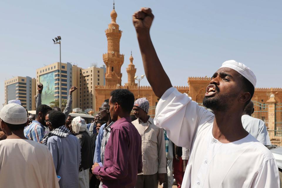 People chant slogans to protest Sudanese President of the Sovereignty Council Abdel Fattah Abdelrahman Burhan's contentious decision to meet Israel's prime minister last week in a move toward normalizing relations, in Khartoum, Sudan, Feb. 7, 2020.