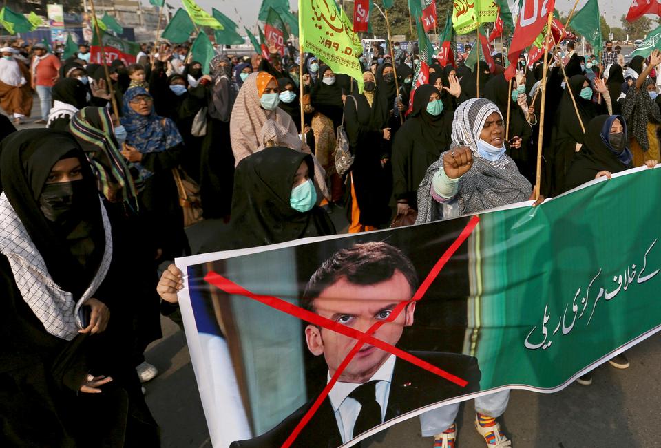 Shia Muslim women march toward the French Consulate during a rally against French President Emmanuel Macron and the republishing of caricatures of the Prophet Muhammad, in Karachi, Pakistan. November, 1, 2020.