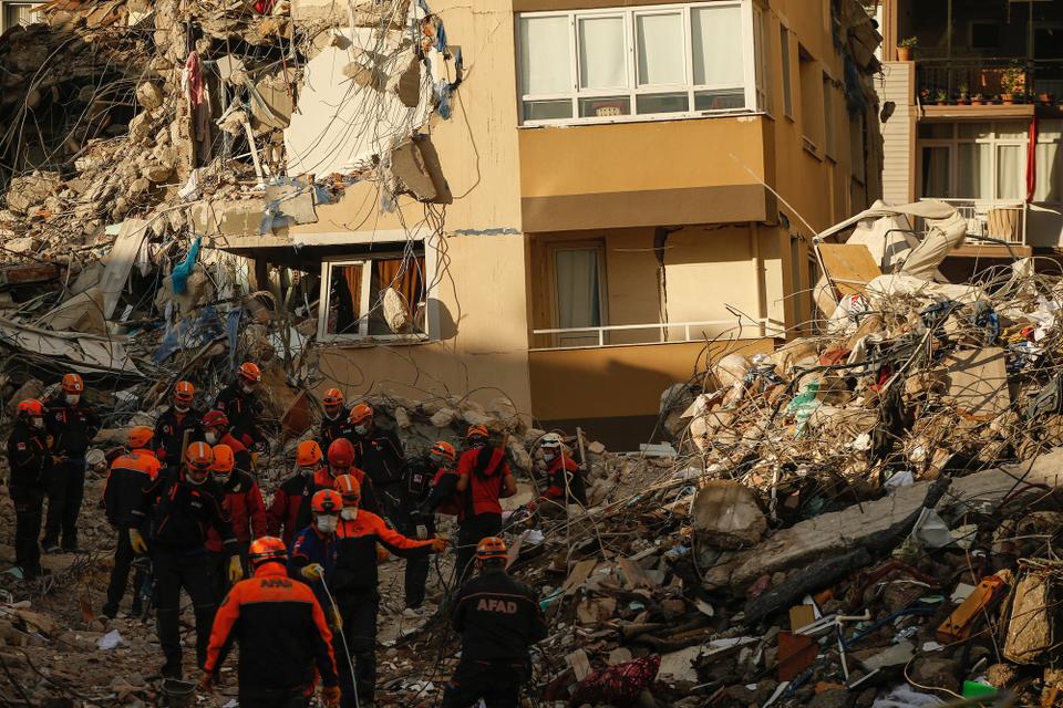 Members of rescue services work at collapsed buildings destroyed in the October 30 earthquake in Izmir, Turkey, Tuesday, November3, 2020.