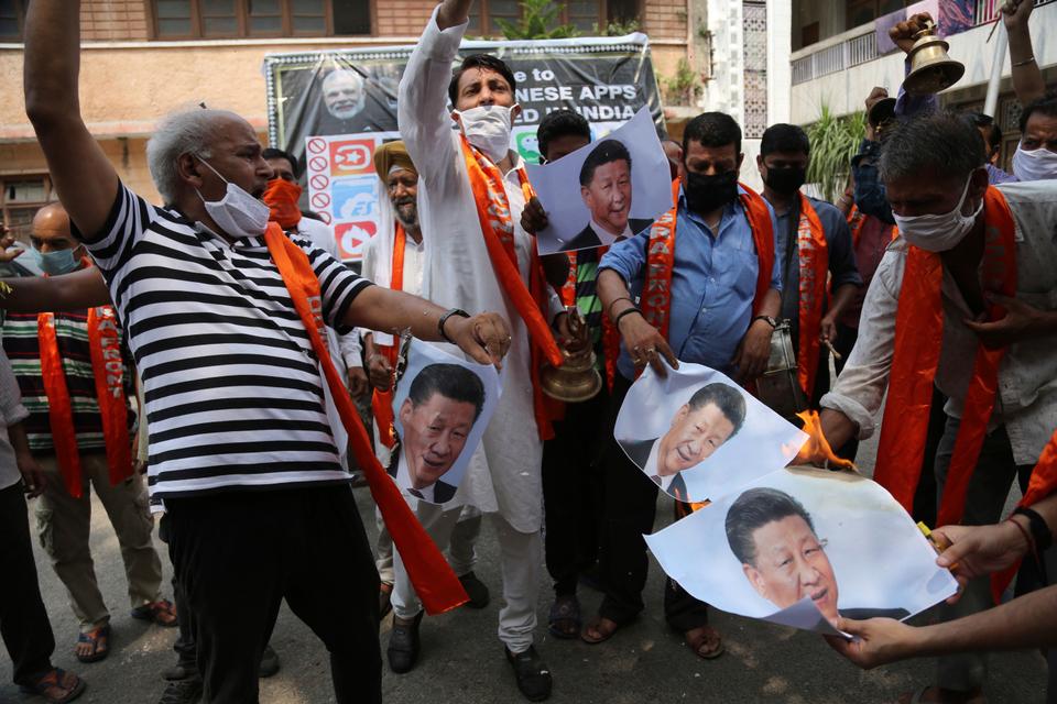 Activists of Jammu and Kashmir Dogra Front shout slogans and burn photographs of Chinese President Xi Jinping during a protest in Jammu, India, Wednesday, July.1, 2020.
