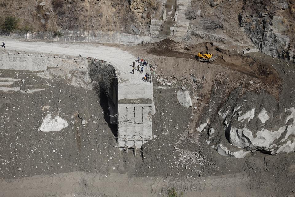 Border Road Organisation workers reconstructing the bridge washed after the flash flood.