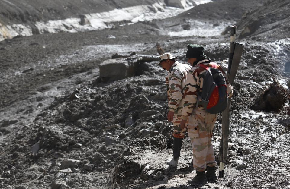 ITBP personnel search for bodies of workers in the mud of Rishi Ganga river near Raini Village in Chamoli District of Uttarakhand.